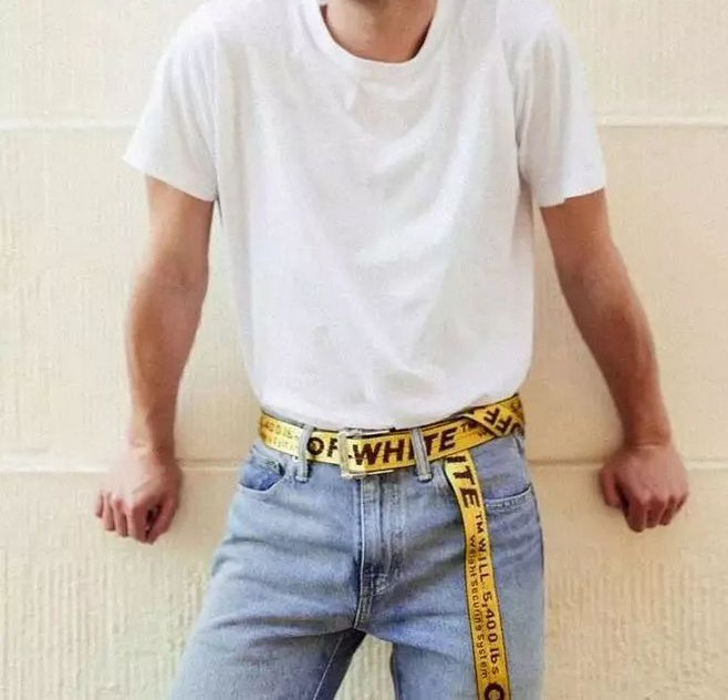 A young man chooses a yellow belt,looks so fashion