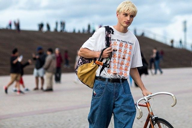 A  cool guy ties a fashion belt